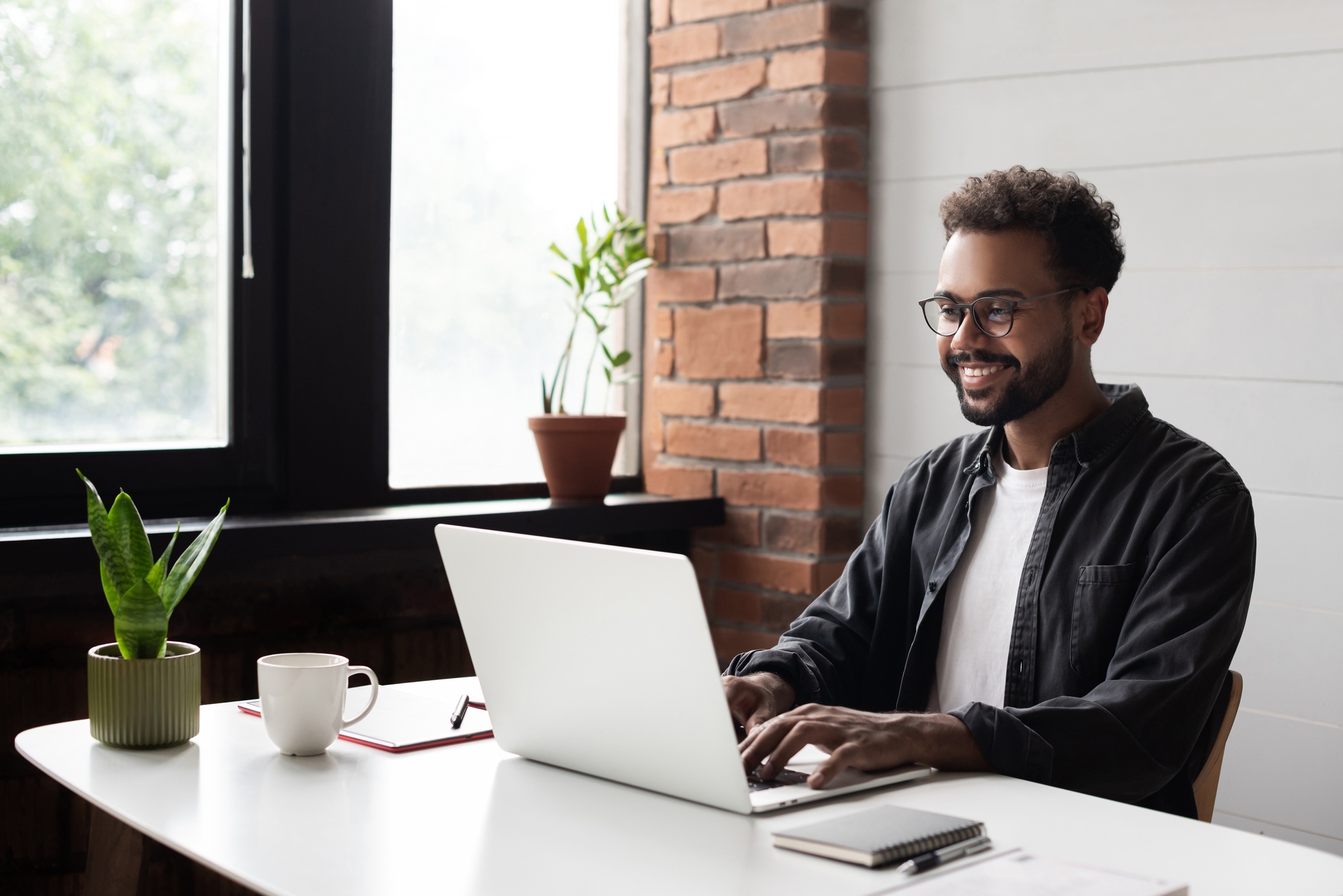 Hispanic male working at computer