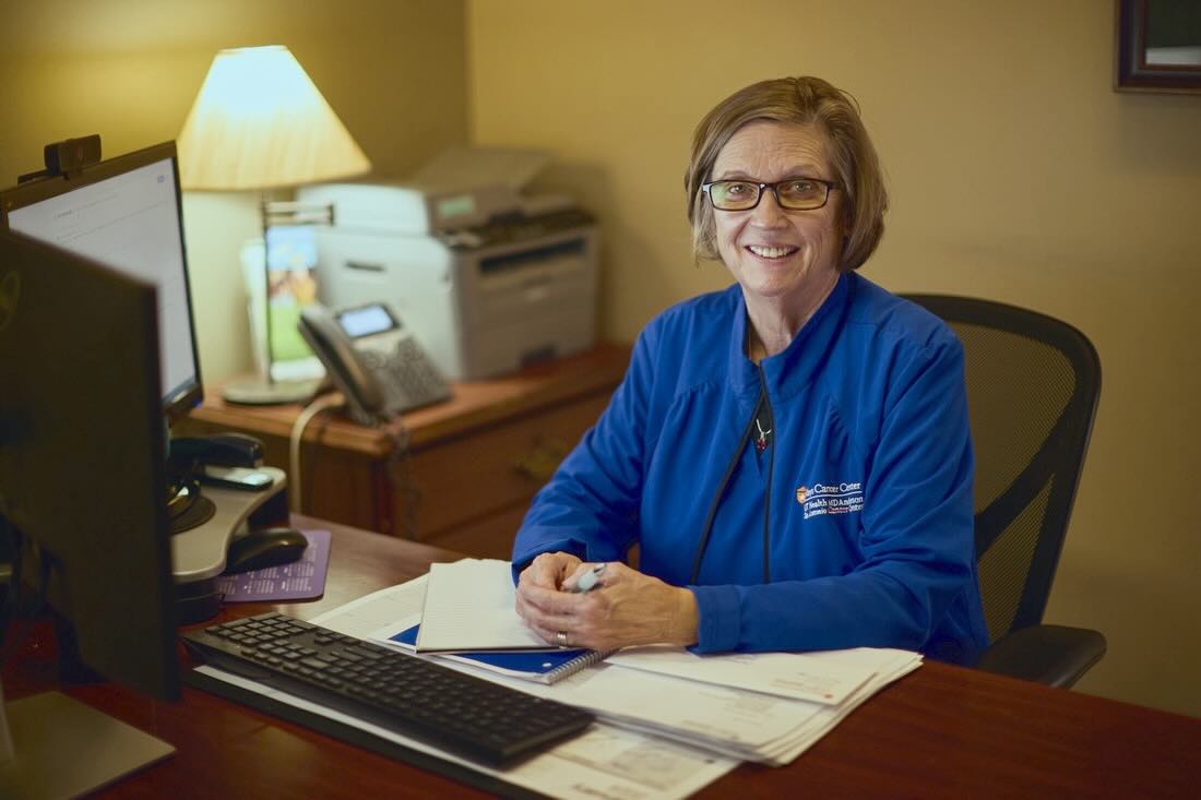 Carol Sherman working at her desk