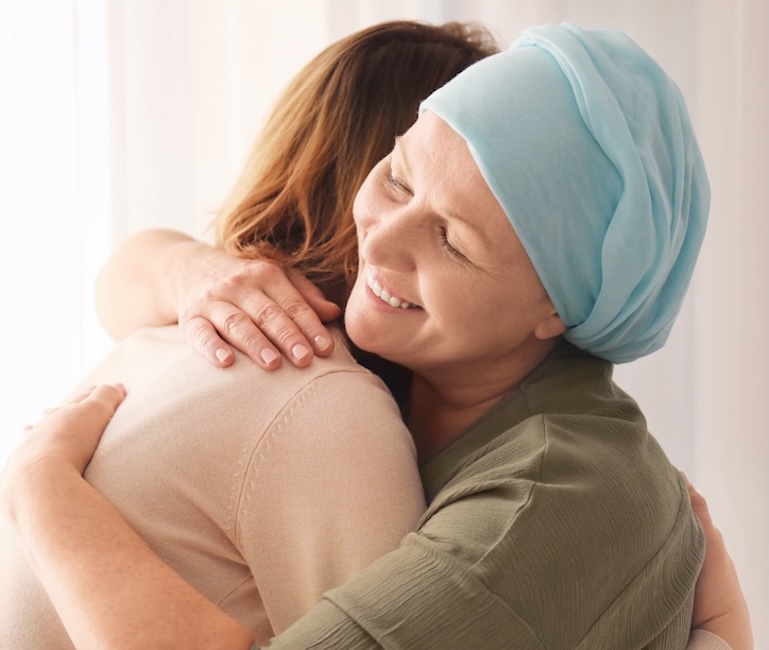 Cancer patient hugging a loved one