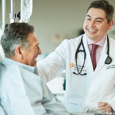 Enrique Diaz Mays Cancer Center smiling with patient