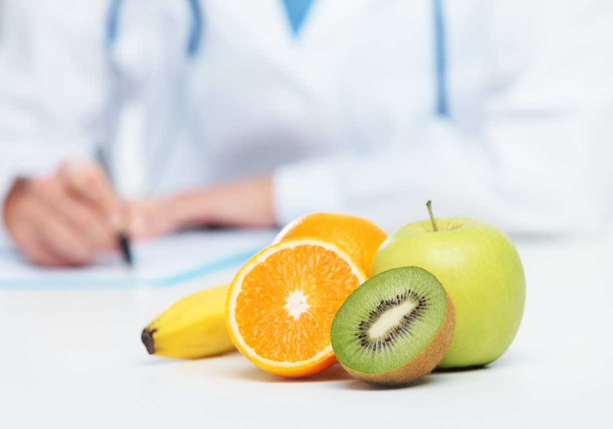 Nutritionist Doctor is writing a prescription. Focus on fruit
