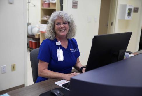 Mary Paig Cokerham RN working at her desk